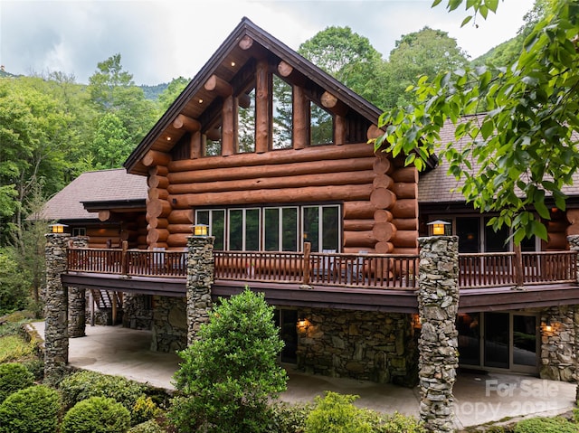 303 Flying Hawk Trl, Waynesville, NC 28786 - rear view of property featuring stone siding, a patio, and log siding