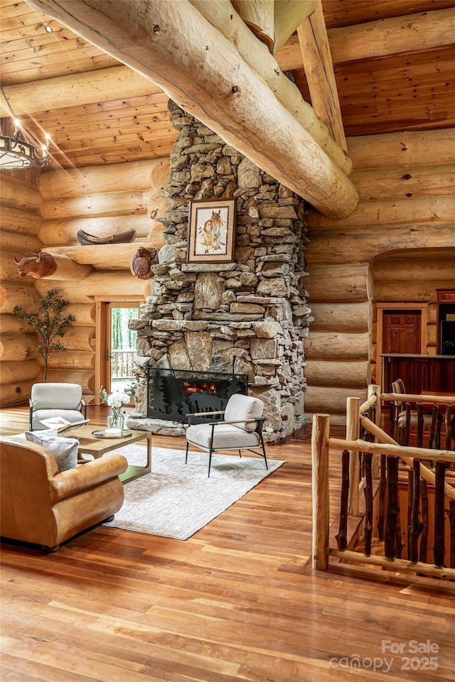 303 Flying Hawk Trl, Waynesville, NC 28786 - living area with a wood ceiling with exposed beams, a fireplace, hardwood / wood-style floors, and log walls