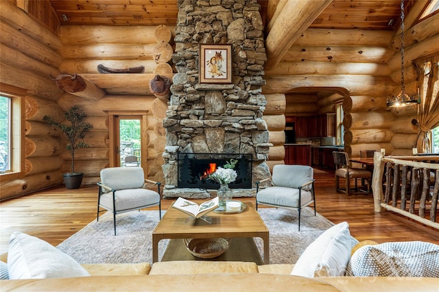 303 Flying Hawk Trl, Waynesville, NC 28786 - living area featuring hardwood / wood-style floors, a stone fireplace, healthy amount of natural light, wood ceiling, and log walls