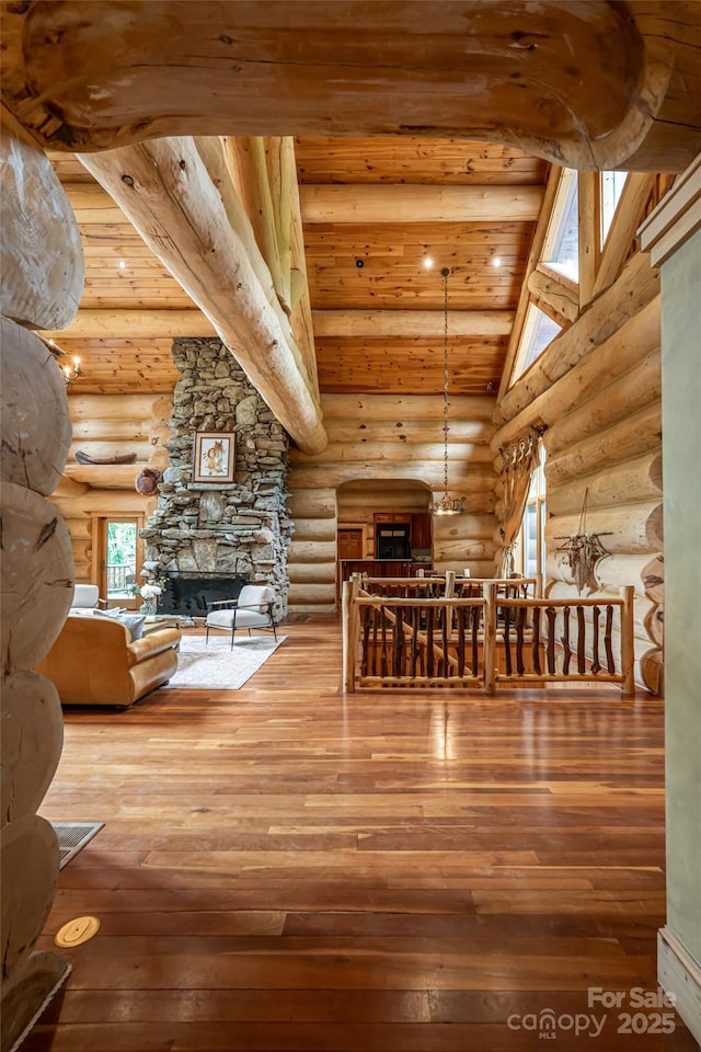 303 Flying Hawk Trl, Waynesville, NC 28786 - hallway with log walls, hardwood / wood-style flooring, wood ceiling, and vaulted ceiling