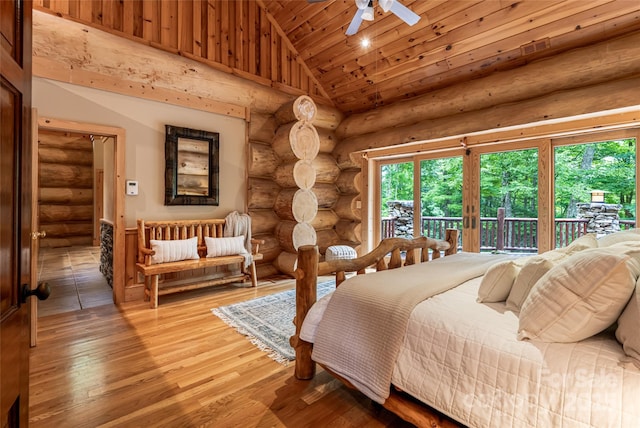 303 Flying Hawk Trl, Waynesville, NC 28786 - bedroom featuring log walls, access to exterior, multiple windows, light wood-style floors, and wooden ceiling
