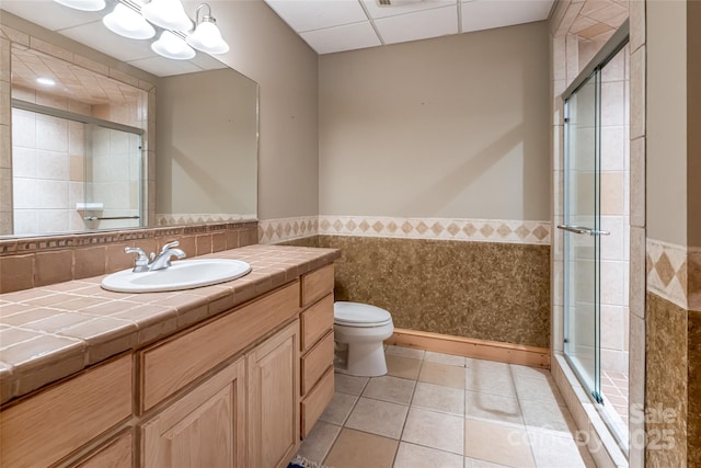 303 Flying Hawk Trl, Waynesville, NC 28786 - bathroom with a shower stall, a wainscoted wall, vanity, tile patterned floors, and tile walls