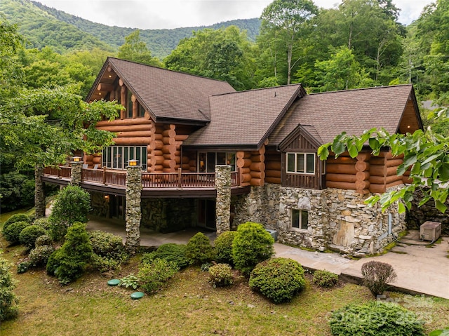 303 Flying Hawk Trl, Waynesville, NC 28786 - rear view of property featuring log siding, stone siding, a patio, and a view of trees