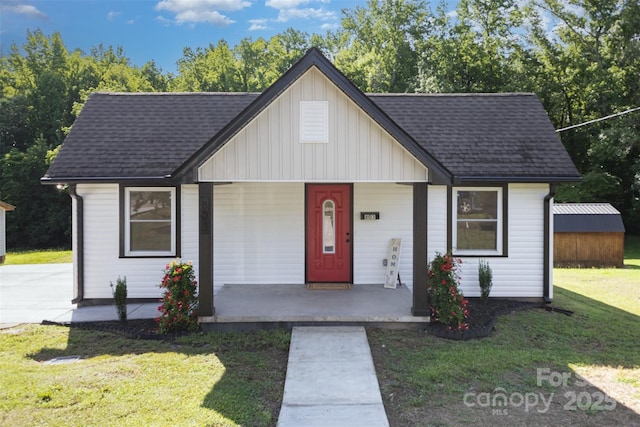 803 Irene Ave, Kannapolis, NC 28083 - view of front of house featuring a porch, board and batten siding, a front yard, and roof with shingles