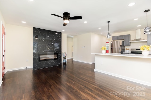803 Irene Ave, Kannapolis, NC 28083 - living room featuring dark wood-style floors, ceiling fan, recessed lighting, and a premium fireplace