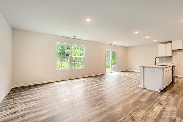 136 Dorian Pl, Troutman, NC 28166 - kitchen with open floor plan, plenty of natural light, light wood-style flooring, light countertops, and recessed lighting