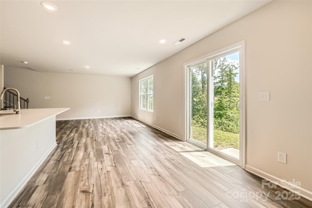136 Dorian Pl, Troutman, NC 28166 - unfurnished living room featuring wood finished floors and recessed lighting