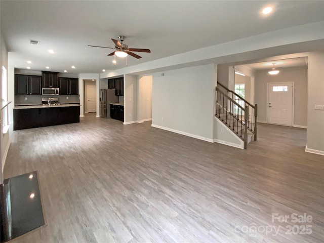 2382 Drake Mill Ln SW, Concord, NC 28025 - unfurnished living room with stairway, recessed lighting, wood finished floors, and a ceiling fan