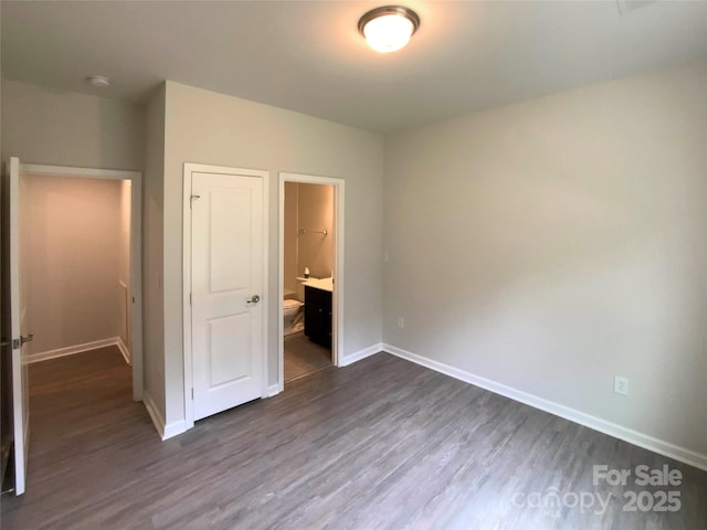 2382 Drake Mill Ln SW, Concord, NC 28025 - unfurnished bedroom featuring dark wood-style flooring and ensuite bathroom