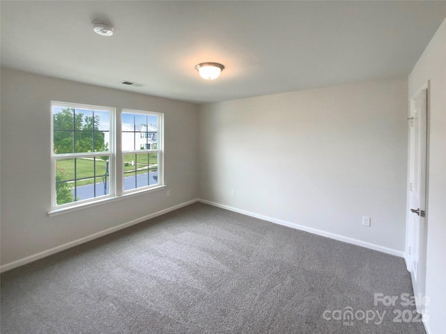 2382 Drake Mill Ln SW, Concord, NC 28025 - empty room with dark carpet and a smoke detector