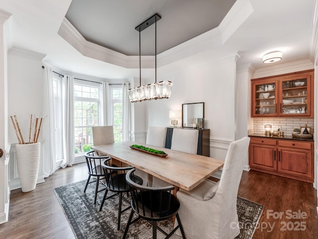 3036 Luke Crossing Dr, Charlotte, NC 28226 - dining space with a raised ceiling, dark wood-type flooring, and crown molding