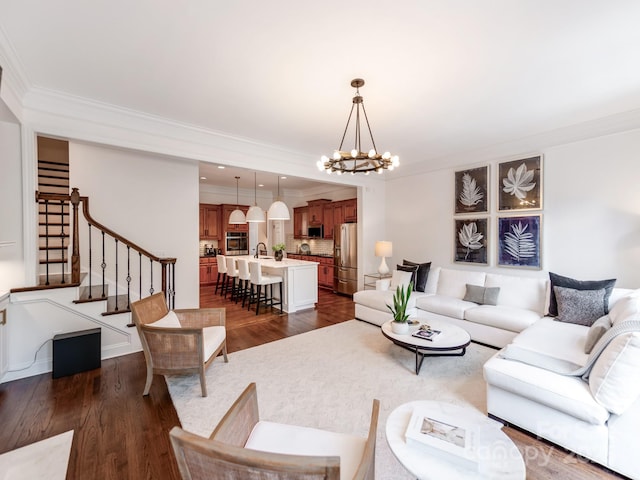 3036 Luke Crossing Dr, Charlotte, NC 28226 - living room with a chandelier, crown molding, dark wood-style floors, and stairs
