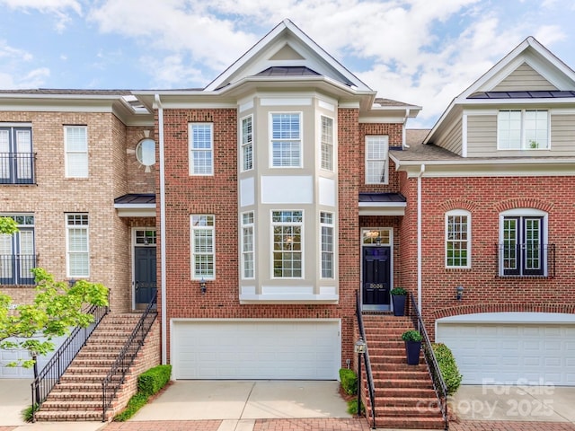 3036 Luke Crossing Dr, Charlotte, NC 28226 - view of front of home with decorative driveway, a garage, brick siding, and stairs