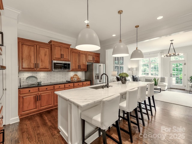 3036 Luke Crossing Dr, Charlotte, NC 28226 - kitchen with stainless steel appliances, brown cabinets, dark wood-type flooring, ornamental molding, and a breakfast bar