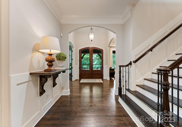 408 Covington Xing, Matthews, NC 28104 - entryway featuring arched walkways, ornamental molding, french doors, dark wood-style floors, and stairway