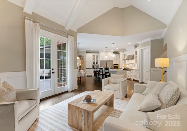 408 Covington Xing, Matthews, NC 28104 - living area with lofted ceiling, wood finished floors, french doors, wainscoting, and ornamental molding