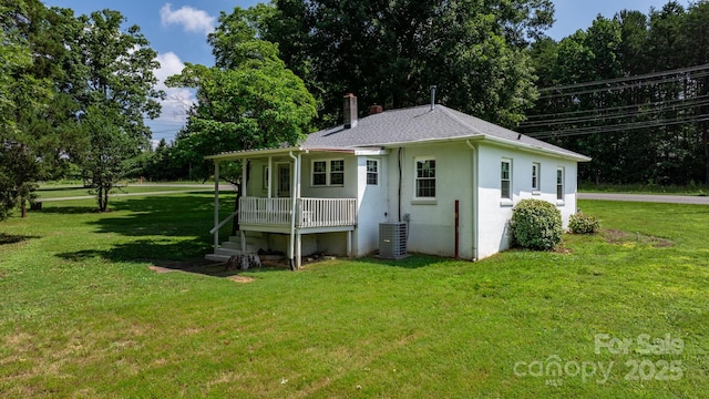921 Spencer Rd NE, Conover, NC 28613 - rear view of property with a lawn, a chimney, covered porch, stucco siding, and a shingled roof