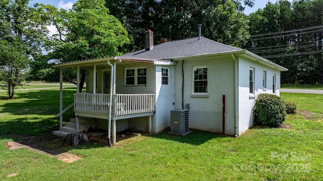 921 Spencer Rd NE, Conover, NC 28613 - back of house featuring a chimney, a porch, a yard, stucco siding, and a shingled roof