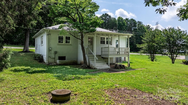 921 Spencer Rd NE, Conover, NC 28613 - view of front of home with a porch, a front lawn, a metal roof, and stucco siding