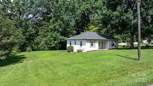 921 Spencer Rd NE, Conover, NC 28613 - view of front facade with a front yard, stucco siding, and a shingled roof