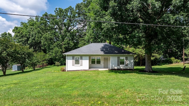 921 Spencer Rd NE, Conover, NC 28613 - view of front facade featuring a front yard, a shed, stucco siding, and roof with shingles