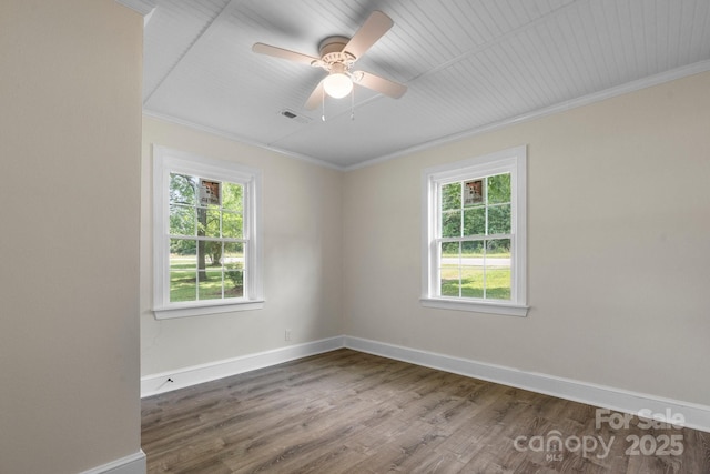 921 Spencer Rd NE, Conover, NC 28613 - unfurnished room featuring plenty of natural light, ornamental molding, wood finished floors, and a ceiling fan