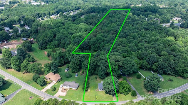 921 Spencer Rd NE, Conover, NC 28613 - aerial overview of property's location with a heavily wooded area and property boundaries highlighted