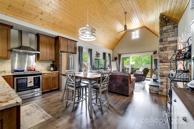 396 River Club Dr, Cullowhee, NC 28723 - kitchen with wall chimney range hood, stainless steel appliances, ceiling fan, open floor plan, and high vaulted ceiling