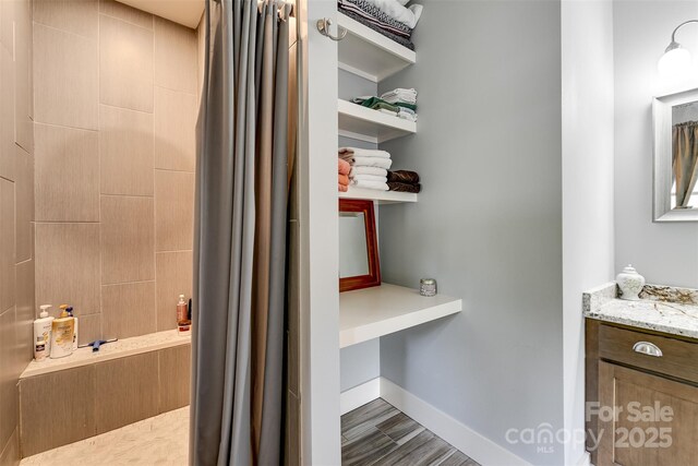 396 River Club Dr, Cullowhee, NC 28723 - full bath with tiled shower, vanity, and wood finished floors