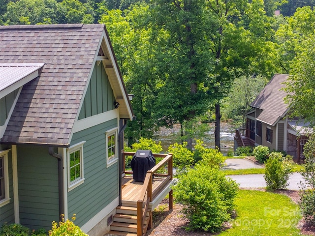396 River Club Dr, Cullowhee, NC 28723 - view of property exterior featuring a shingled roof, a deck with water view, and board and batten siding