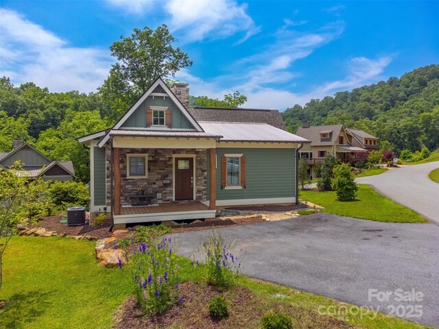 396 River Club Dr, Cullowhee, NC 28723 - view of front of property featuring covered porch, a front lawn, a chimney, a metal roof, and stone siding
