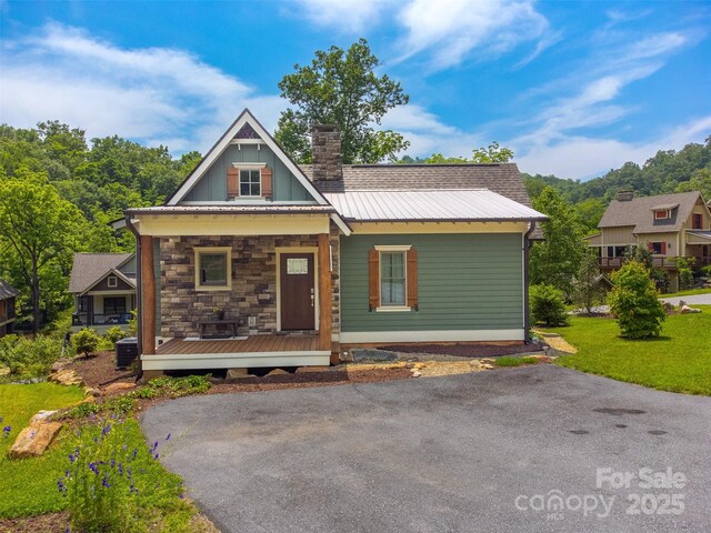 396 River Club Dr, Cullowhee, NC 28723 - view of front of house with a chimney, covered porch, a metal roof, and a front lawn