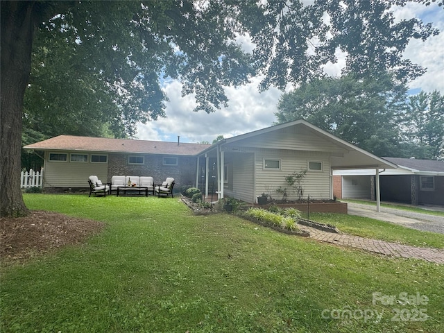 1107 Crestfield Dr, Lancaster, SC 29720 - rear view of house with outdoor lounge area, a lawn, an attached carport, and driveway
