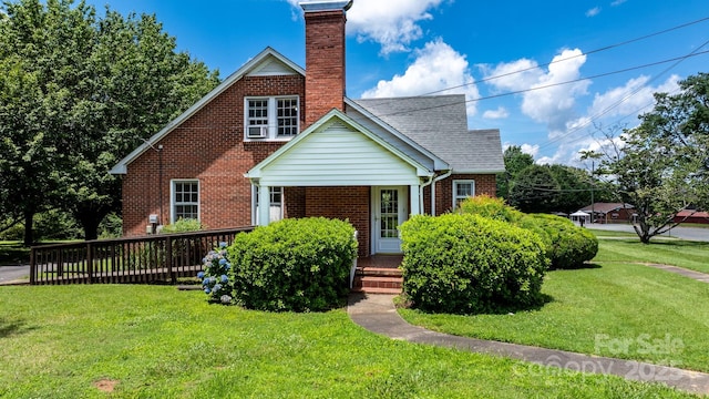 1520 21st Ave NE, Hickory, NC 28601 - view of front facade featuring brick siding, a chimney, and a front yard