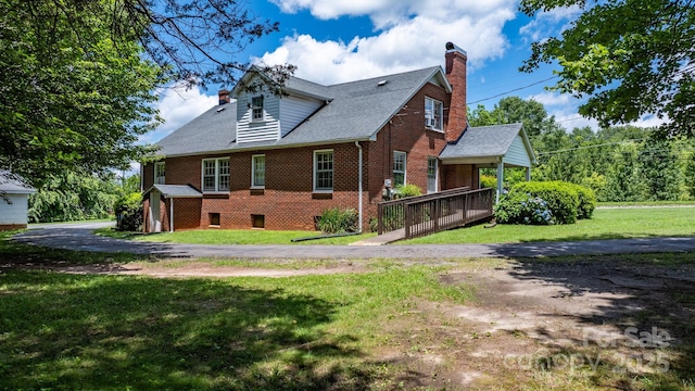 1520 21st Ave NE, Hickory, NC 28601 - view of side of property featuring brick siding, a chimney, a lawn, and a storage unit