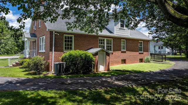 1520 21st Ave NE, Hickory, NC 28601 - view of property exterior featuring brick siding, a lawn, and roof with shingles