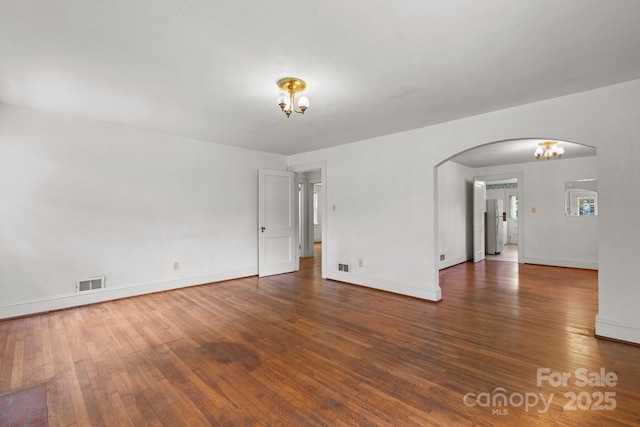 1520 21st Ave NE, Hickory, NC 28601 - spare room featuring wood finished floors, arched walkways, and a chandelier