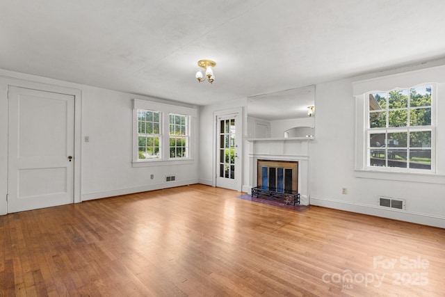 1520 21st Ave NE, Hickory, NC 28601 - unfurnished living room with wood finished floors and a fireplace with flush hearth