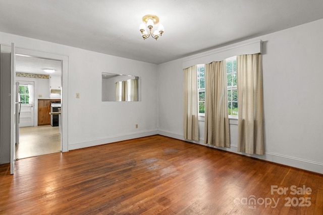 1520 21st Ave NE, Hickory, NC 28601 - empty room with wood finished floors and a chandelier