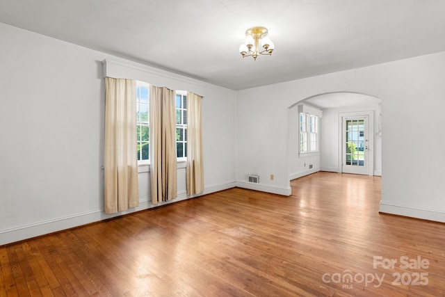 1520 21st Ave NE, Hickory, NC 28601 - spare room featuring arched walkways, light wood-type flooring, and a chandelier