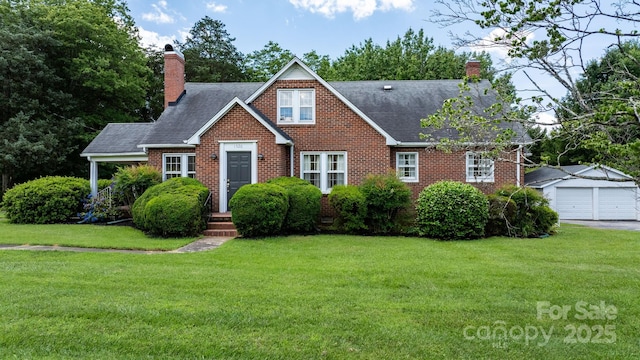 1520 21st Ave NE, Hickory, NC 28601 - tudor home with a chimney, a front yard, brick siding, and a detached garage