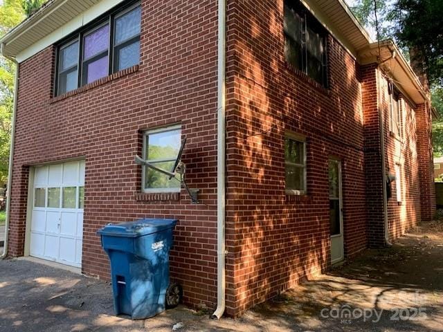 209 8th Ave NW, Hickory, NC 28601 - view of property exterior with an attached garage, brick siding, and driveway