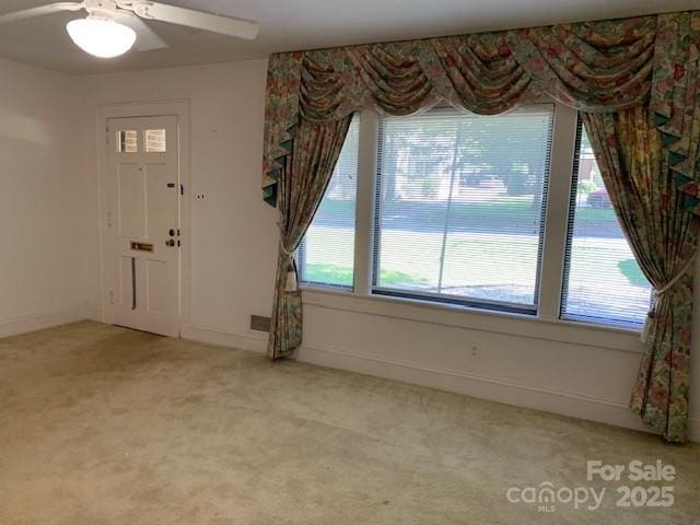 209 8th Ave NW, Hickory, NC 28601 - entrance foyer with healthy amount of natural light, light colored carpet, and a ceiling fan
