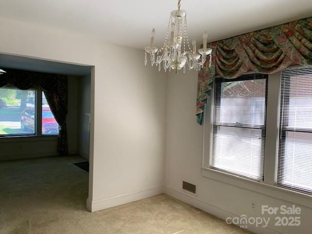 209 8th Ave NW, Hickory, NC 28601 - unfurnished room featuring light colored carpet and a chandelier
