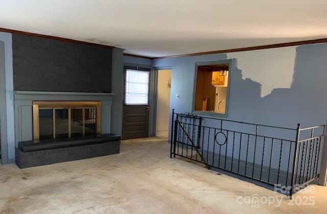 209 8th Ave NW, Hickory, NC 28601 - unfurnished living room with ornamental molding, a fireplace, and carpet