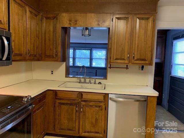209 8th Ave NW, Hickory, NC 28601 - kitchen featuring stainless steel appliances, brown cabinets, and light countertops