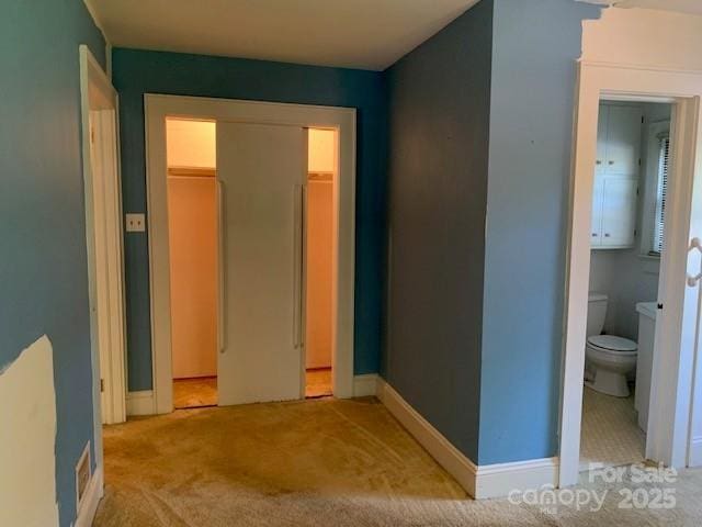 209 8th Ave NW, Hickory, NC 28601 - unfurnished bedroom with light colored carpet, a closet, and ensuite bathroom