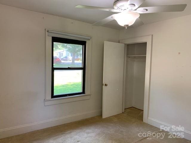 209 8th Ave NW, Hickory, NC 28601 - unfurnished bedroom featuring carpet floors, multiple windows, a closet, and ceiling fan
