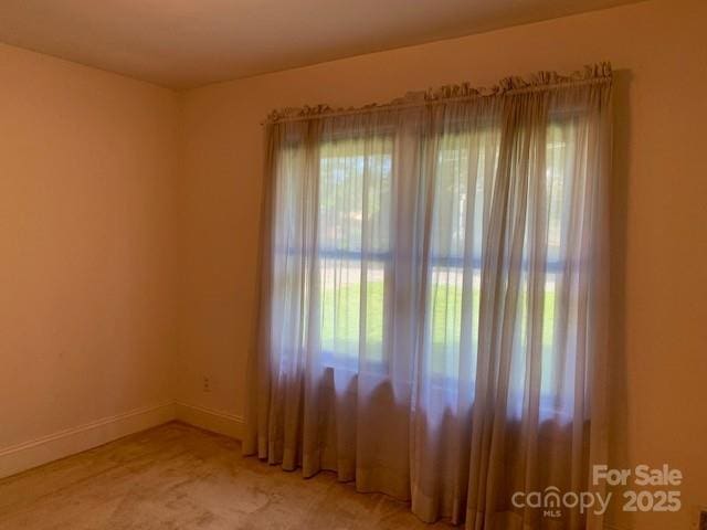 209 8th Ave NW, Hickory, NC 28601 - spare room featuring baseboards and light carpet