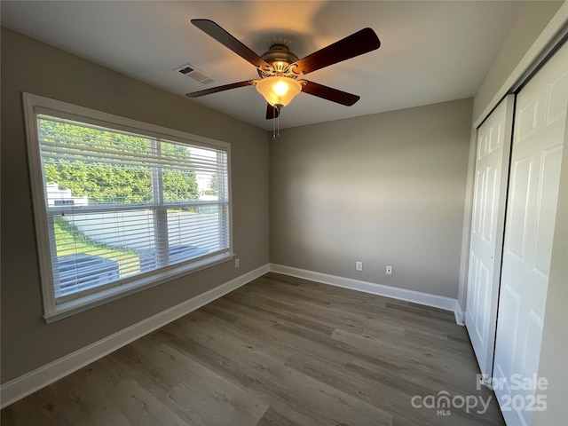 107 Ameena Chase Trl, Mooresville, NC 28117 - unfurnished bedroom with a closet, wood finished floors, and a ceiling fan